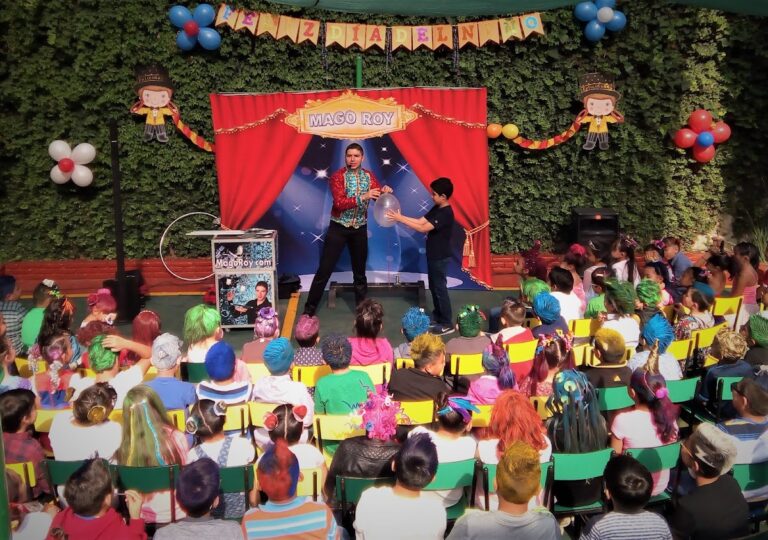 Show de magia de Mago Roy con telón rojo y público infantil en CDMX